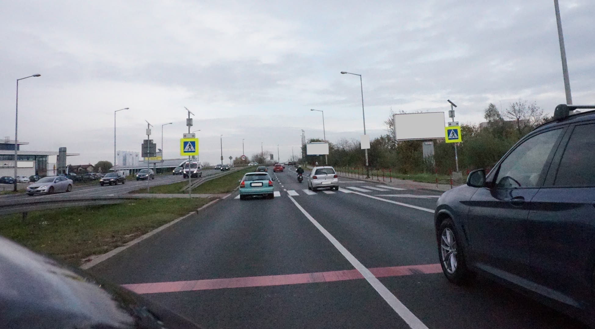 Question illustration: In the given scenario, is it permissible to overtake a vehicle in the adjacent lane just before a pedestrian crossing?