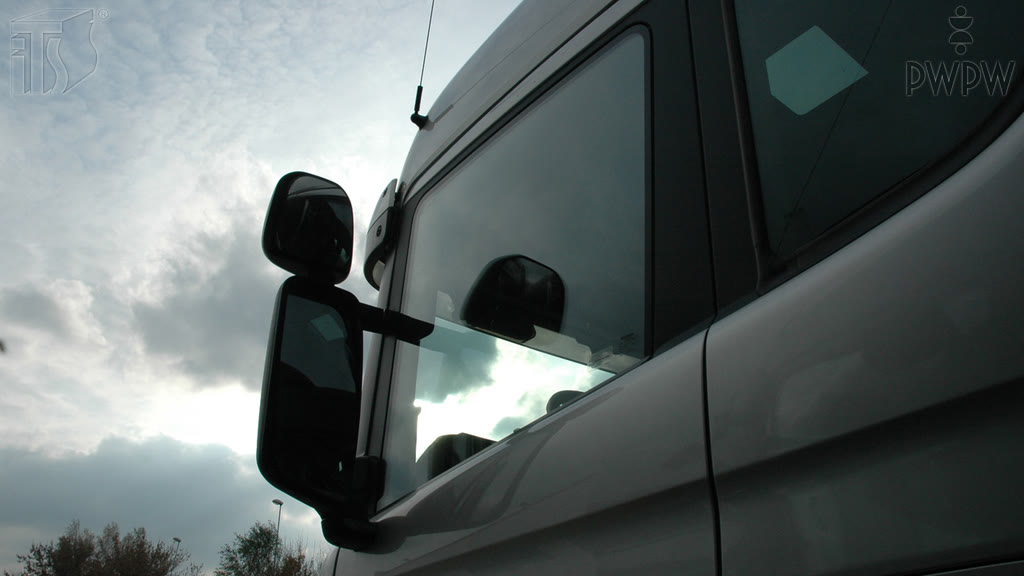 Question illustration: While driving a truck, what should you see in properly-adjusted external mirrors ("rear-view mirrors")?