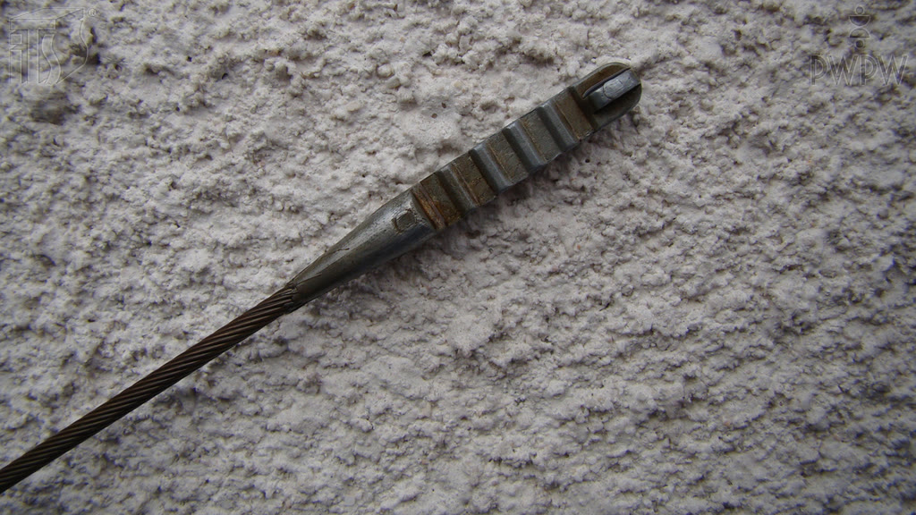 Question illustration: When checking the oil level, which part on the dipstick should have oil on it in order to indicate that the oil level is correct?