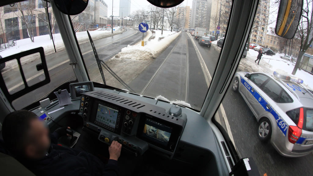Question illustration: Are you allowed to overtake the emergency services vehicle in a built-up area?