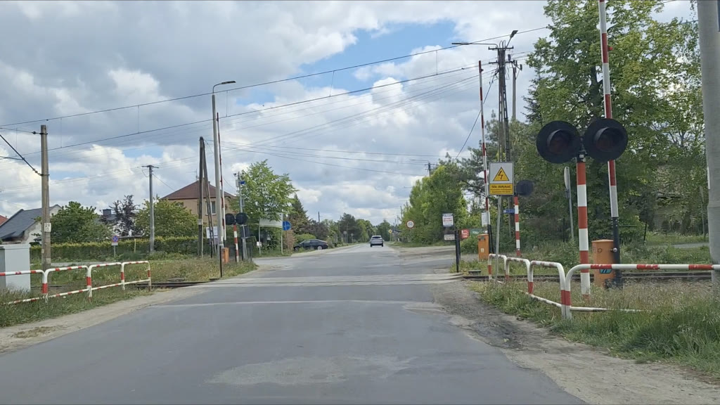 Question illustration: When approaching a level crossing with overhead lines, should you be mindful of the extra risks involved?