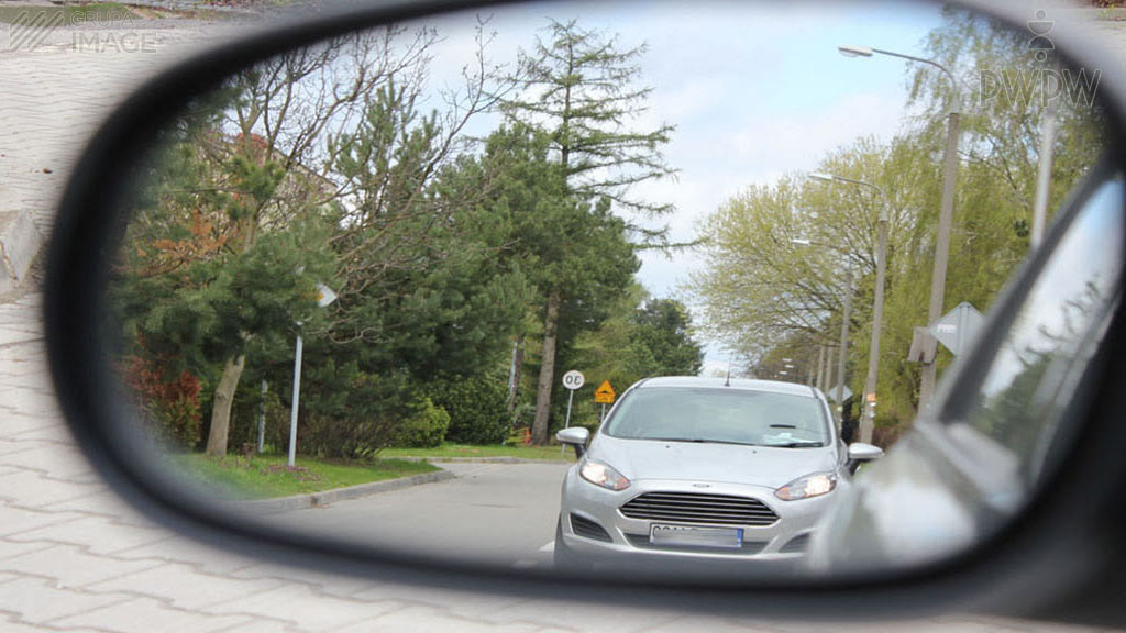 Question illustration: A properly adjusted external mirror on a passenger car shows: