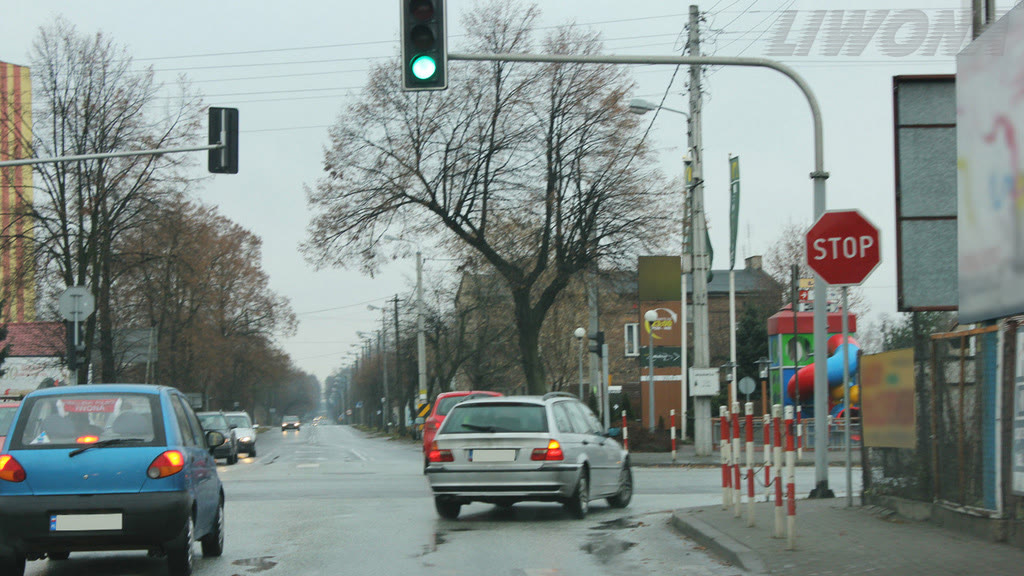 Question illustration: Are you obliged in this situation, to stop before the "STOP" sign if you intend to continue driving straight through the intersection?
